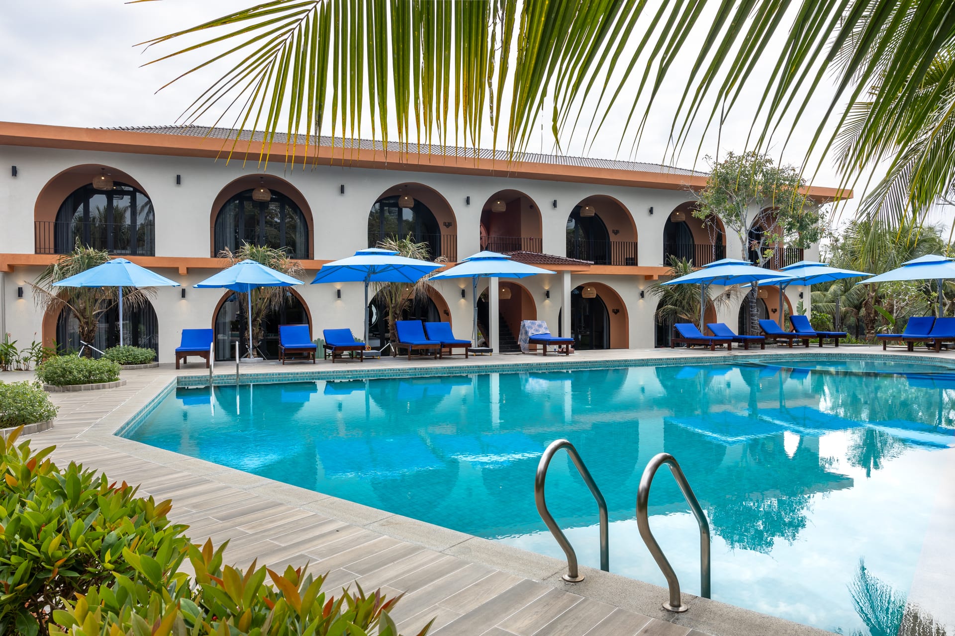 The resort swimming pool and pool-view rooms in daylight